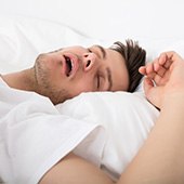 Family asleep in the same bed 