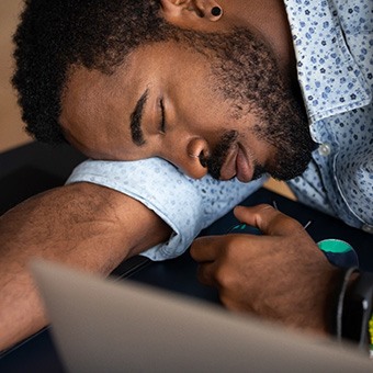 Man falling asleep at work